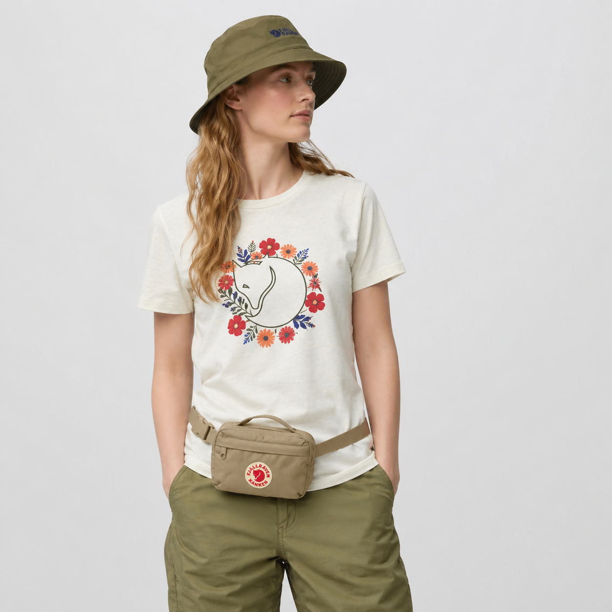 Model wearing a Fjallraven Kanken hip pack in clay colourway.