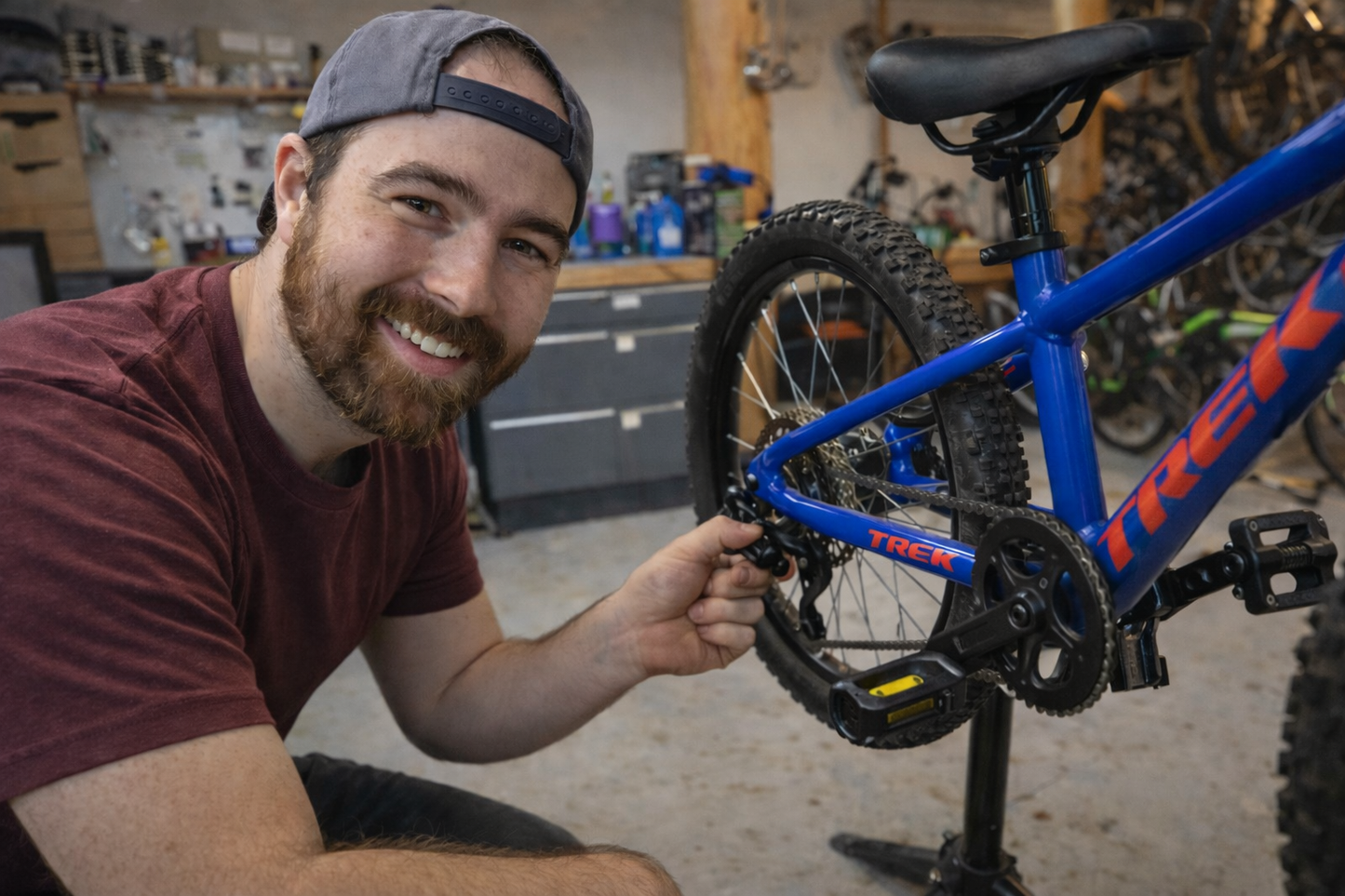 Maveric Northcott Owner of Wells Gray Outfitters in Clearwater BC repairing a kids bike