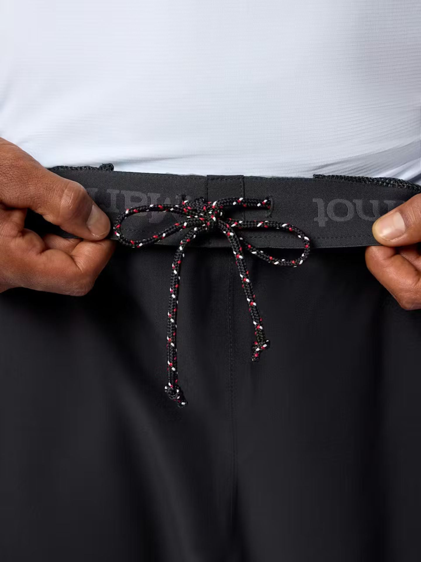 Black Mamrot rain pants with a drawstring and elastic waistband