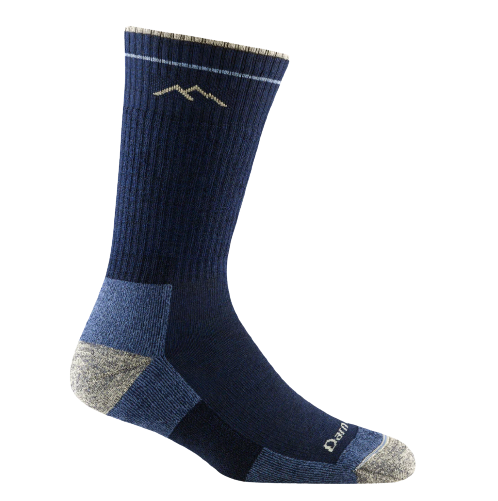 A pair of navy blue Darn Tough women's hiker midweight boot cut socks with a mountain range design near the top.