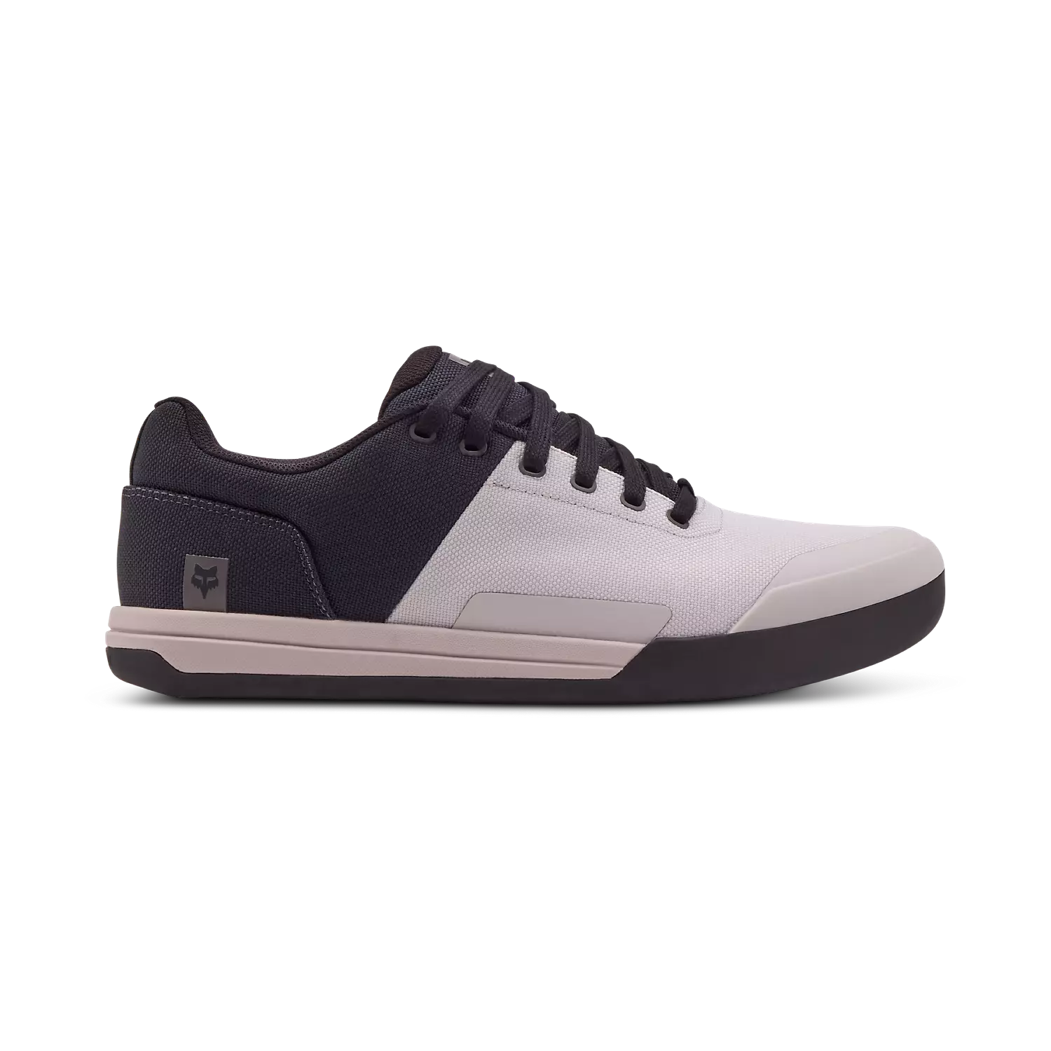 A pair of Fox Union Canvas MTB Shoes featuring a low-top design, lace-up closure, and a white and black color scheme with a rubber sole.