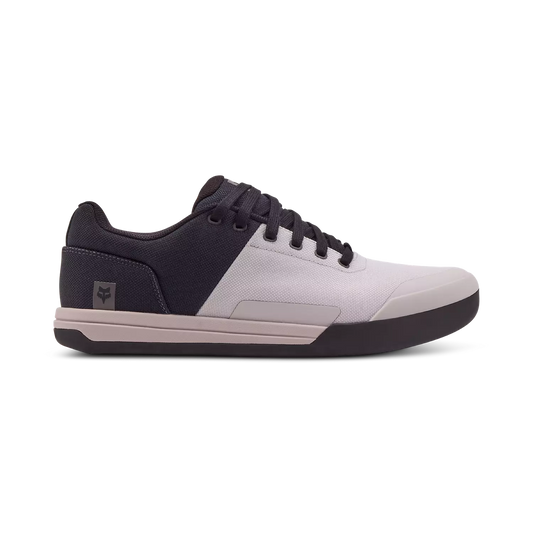 A pair of Fox Union Canvas MTB Shoes featuring a low-top design, lace-up closure, and a white and black color scheme with a rubber sole.