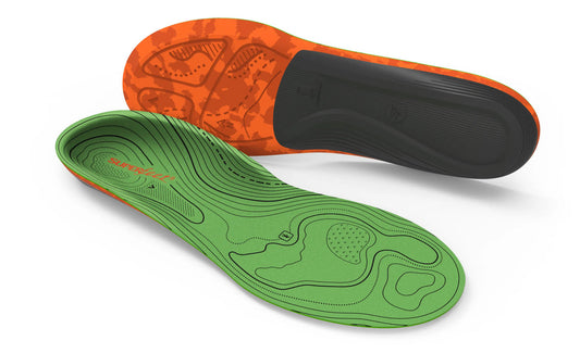 Two hiking insoles shown on a white background, one displaying the green contoured footbed and the other showing the orange and black outsole.